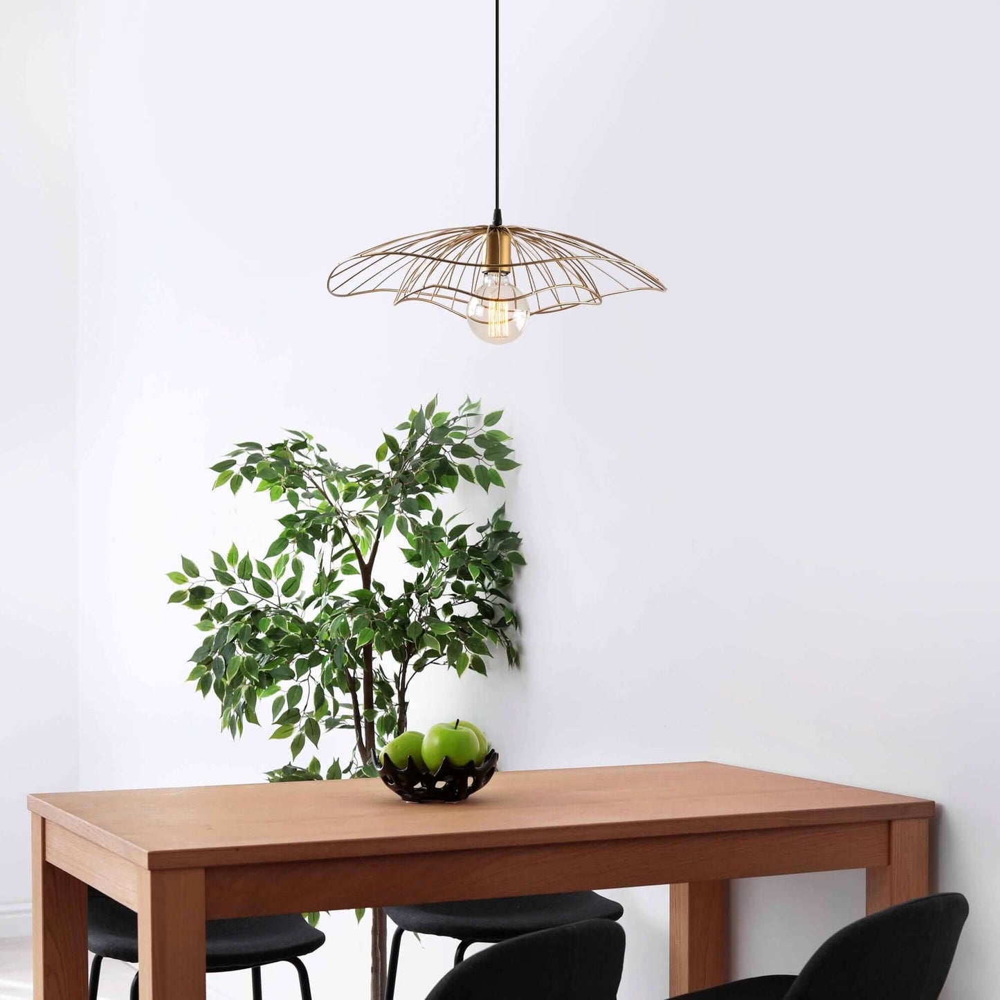 Golden wire petal pendant light with exposed bulb, luxurious and artistic decor element.