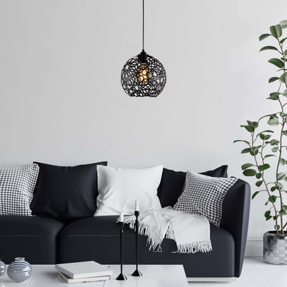 Black lattice globe pendant light with exposed bulb, casting intricate shadows for artistic ambiance.