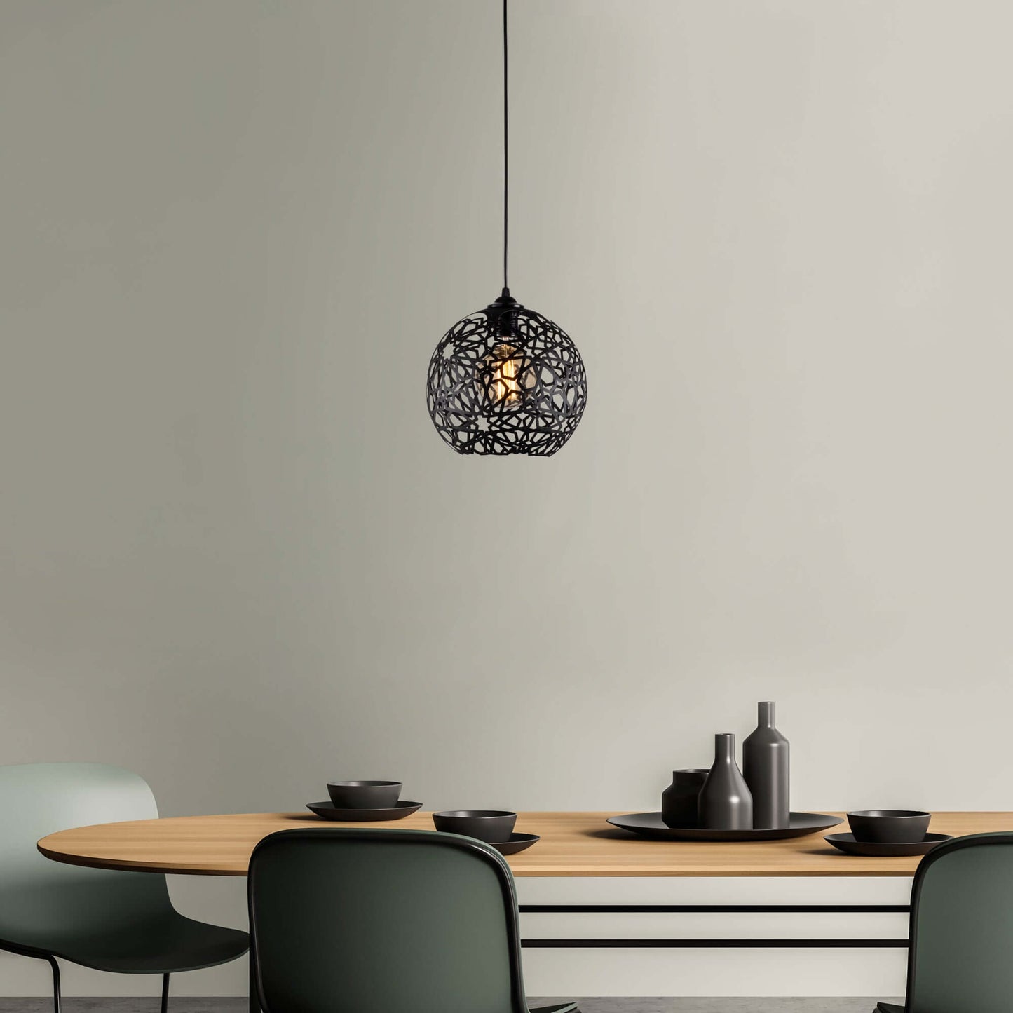 Lattice globe pendant light with black lattice design and exposed bulb casting beautiful shadows.