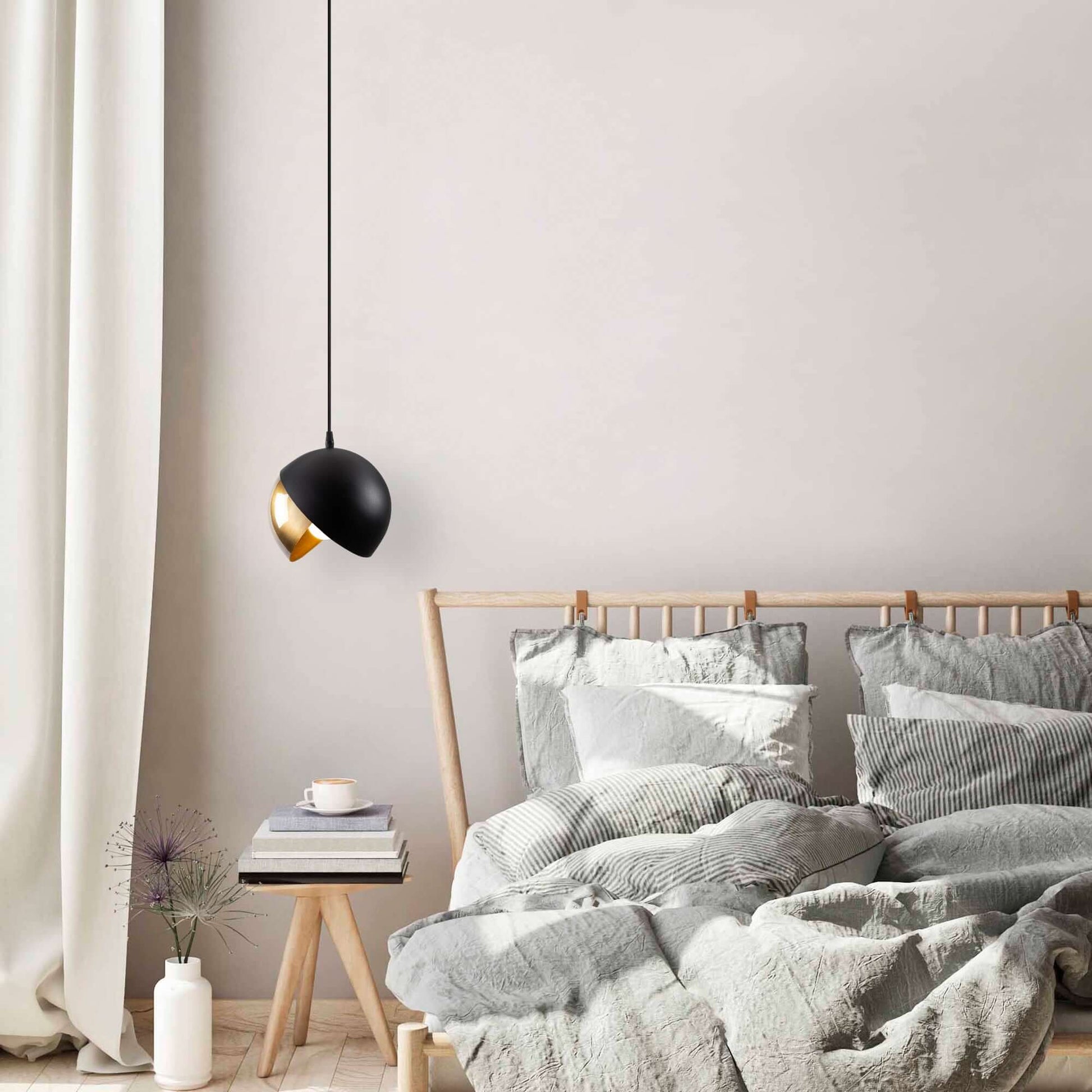 Contemporary black and gold sphere pendant light for modern decor.