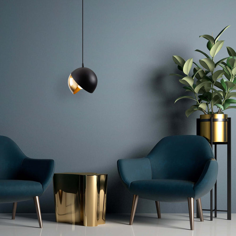 Contemporary black and gold tilted sphere pendant light for modern decor.