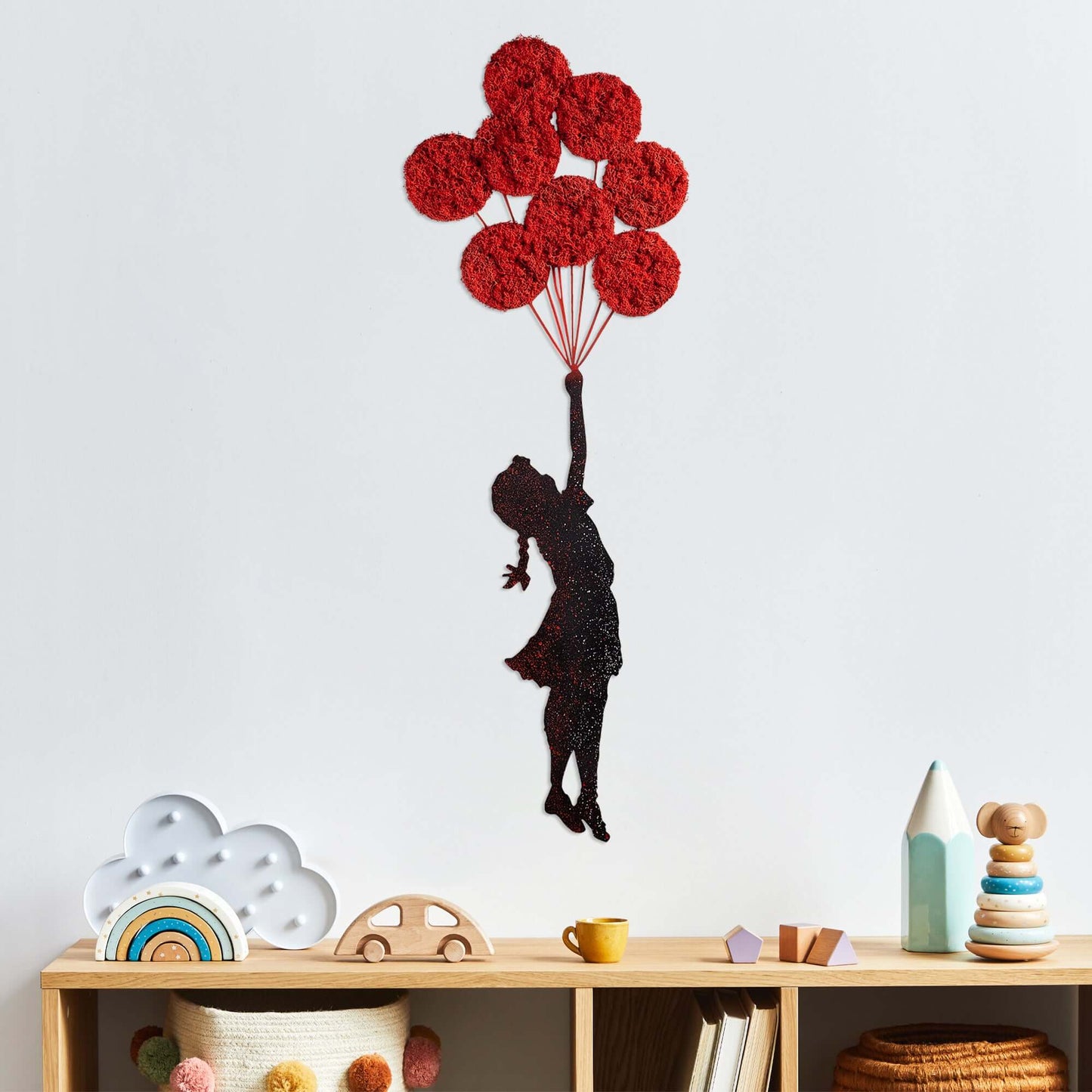 Metal wall decor of girl with red balloons, whimsical and enchanting.