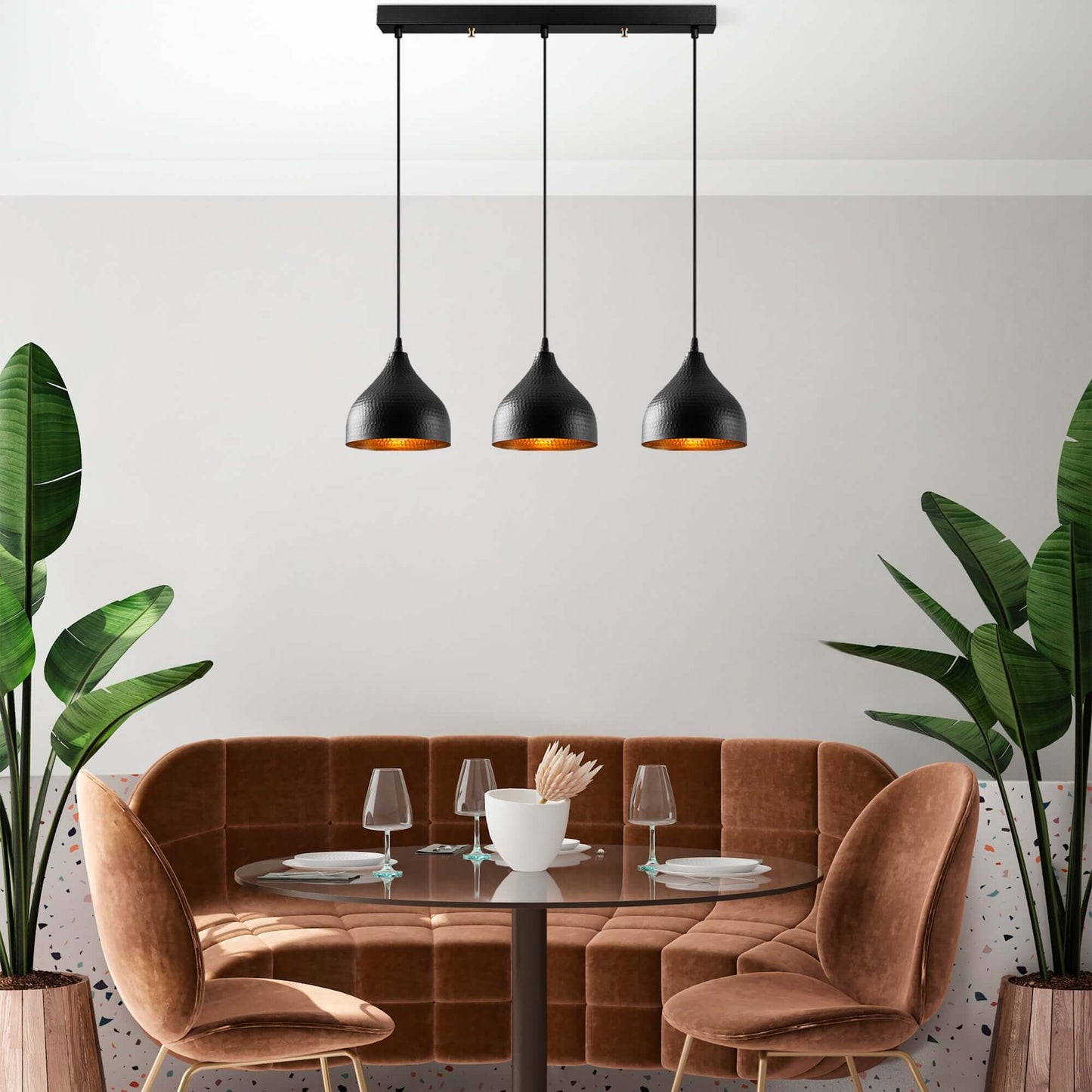 Industrial black pendant lights with warm amber glow, perfect for dining room, kitchen, or living space.