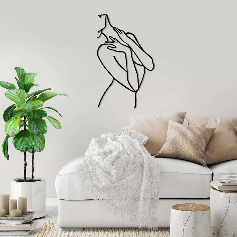 Elegant metal wall decor featuring graceful figure silhouette in gentle pose for living room or bedroom ambiance.