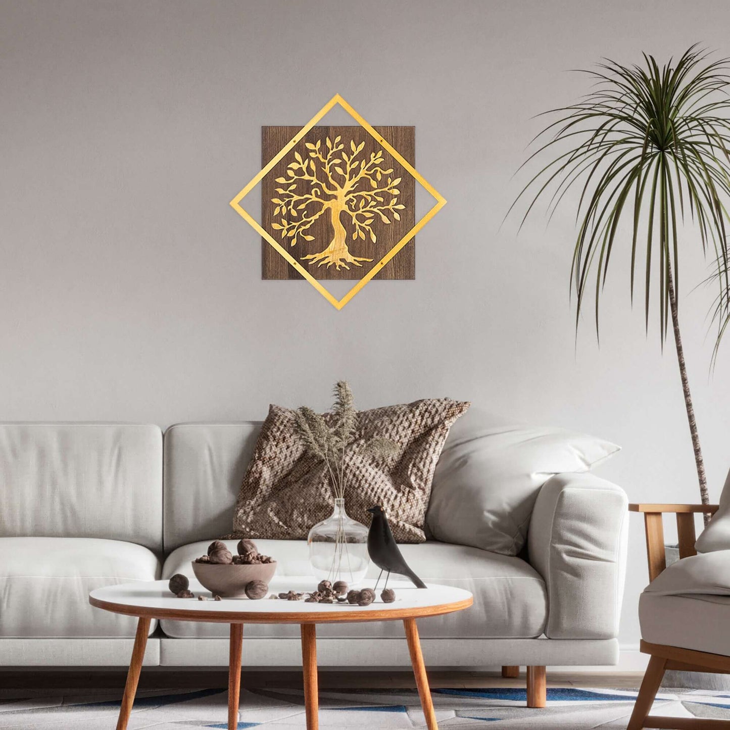 Golden metal tree wall decor on wood backing, adding warmth and nature's charm to living space.