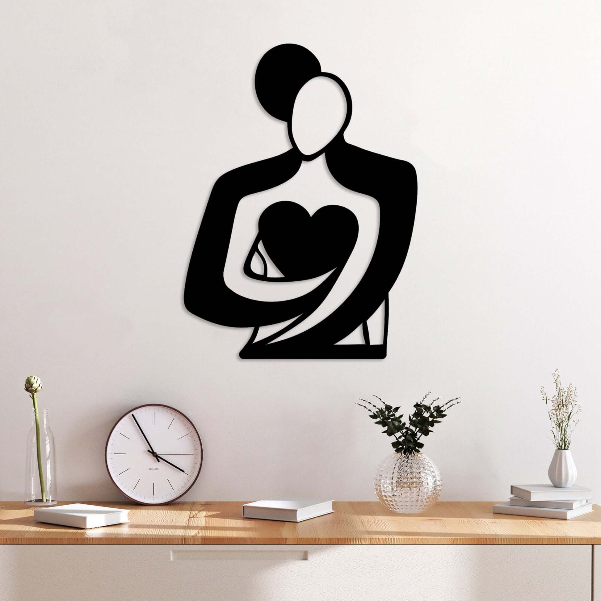 Modern black metal wall decor silhouette of loving embrace.