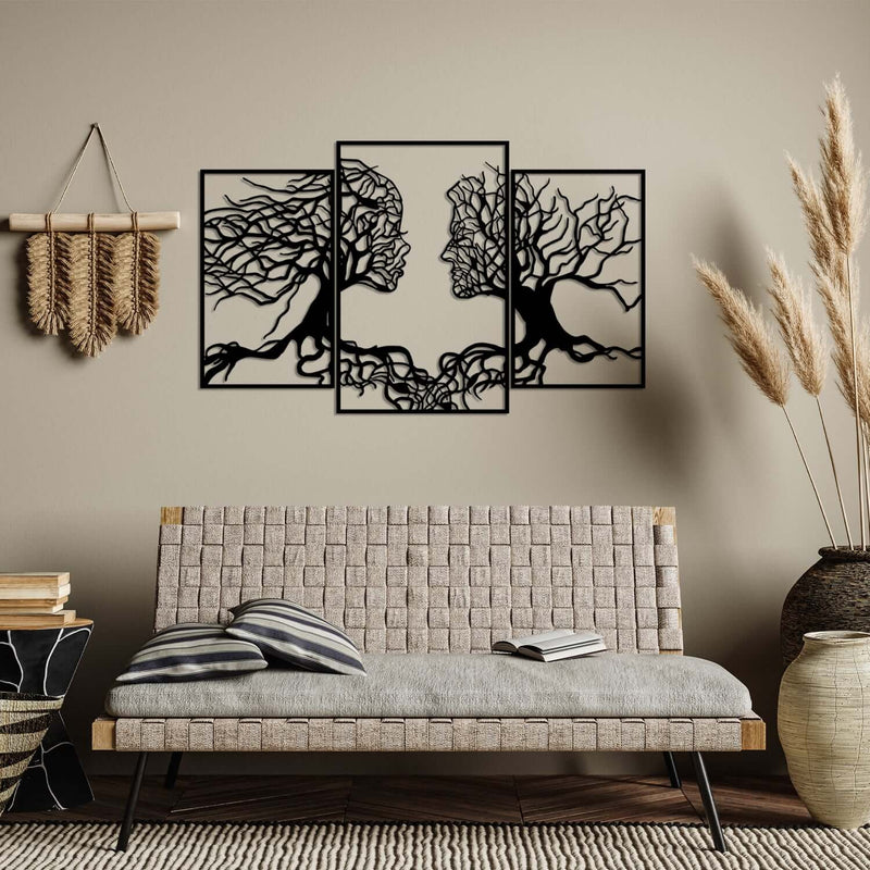 Elegant metal wall decor featuring intricate tree branches forming human figures.